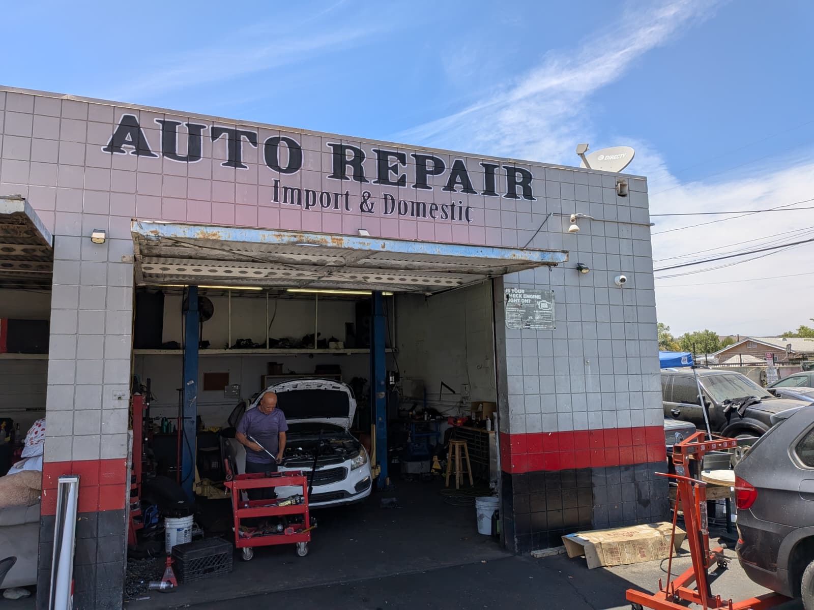 Engine Bros Auto Repair storefront with vehicles being worked on